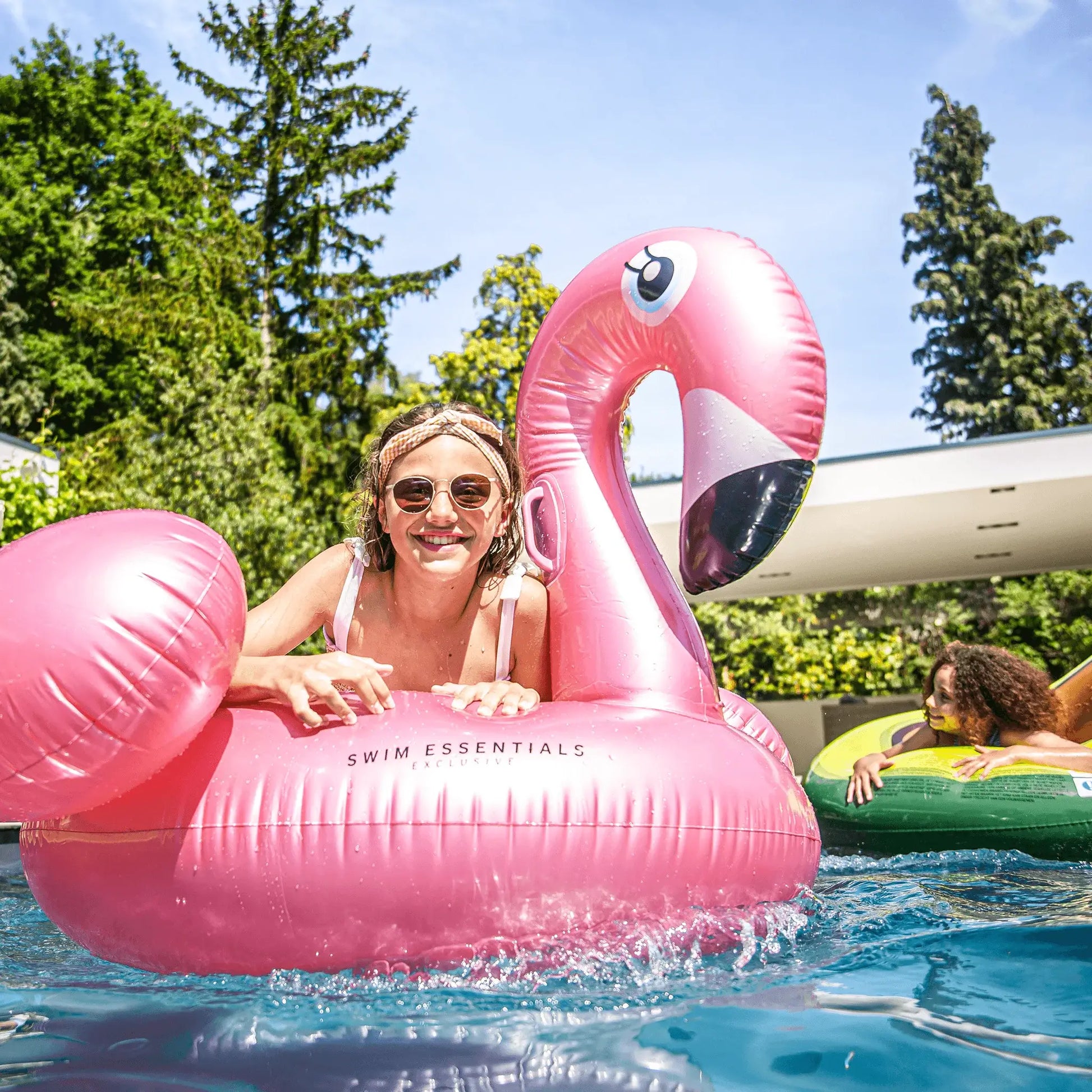 opblaas flamingo zwembad rose goud roze opblaas artikelen zwembad ride on swim essentials sfeerfoto meisjes in zwembad met luchtmatras